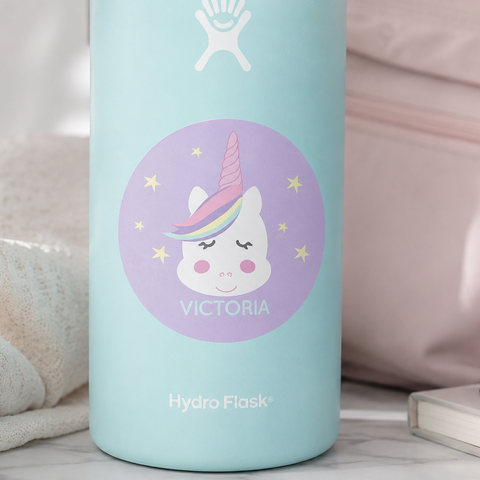 Light blue Hydro Flask tumbler with a unicorn sticker personalized with your name