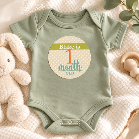 Baby wearing a personalized first month milestone sticker on a onesie
