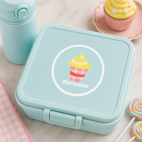 Personalized cupcake waterproof name label on a mint green lunch box with matching water bottle, pastel cupcake props, and coordinated school lunch accessories.