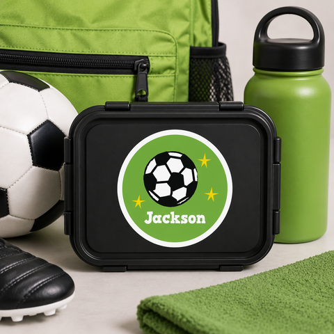 Green and black soccer ball name label on a kids black bento lunchbox for school and sports - Label Circus